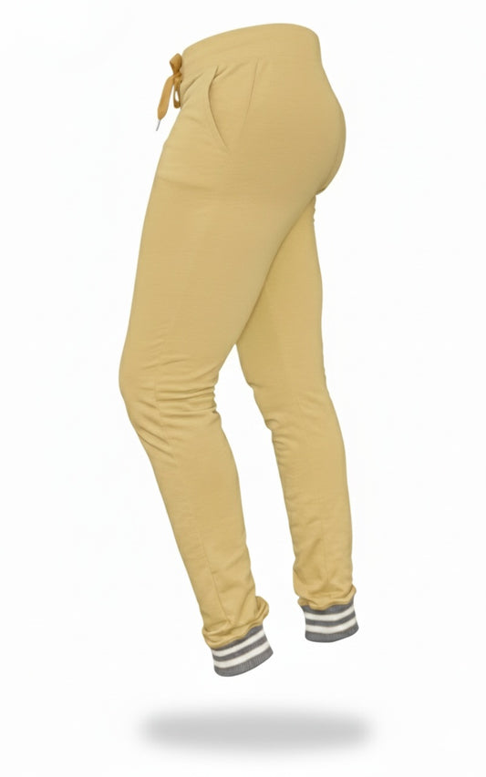 Mustard yellow jogger pants with striped cuffs on a white background