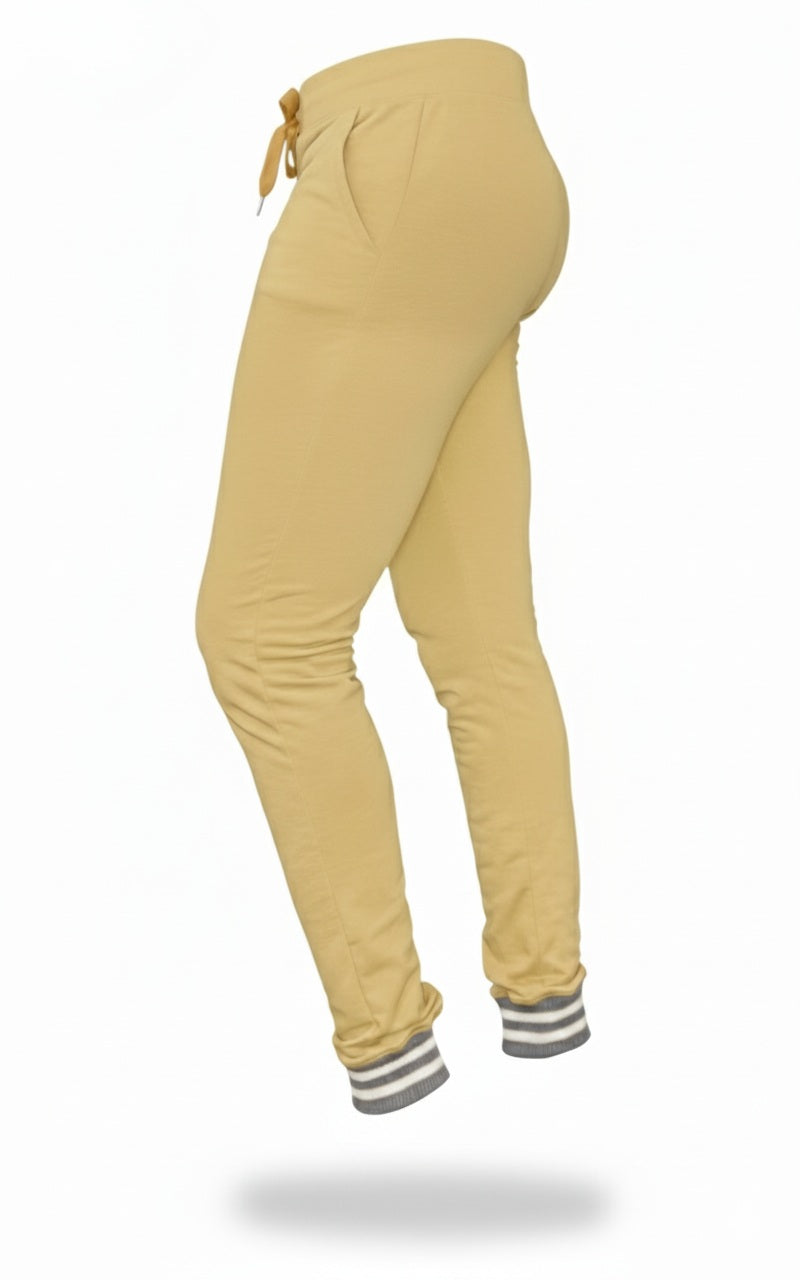 Mustard yellow jogger pants with striped cuffs on a white background
